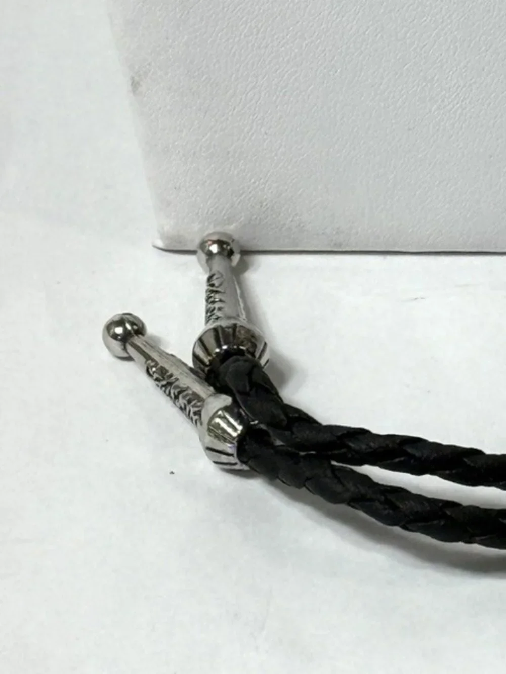 Turquoise-tone stone, black cord western cowboy bolo tie.